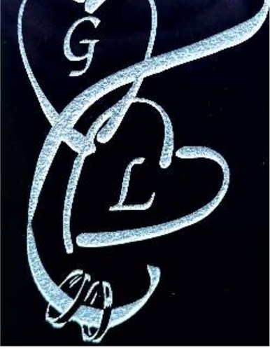 Example laser engraving - entwined heart monogram with initials and rings